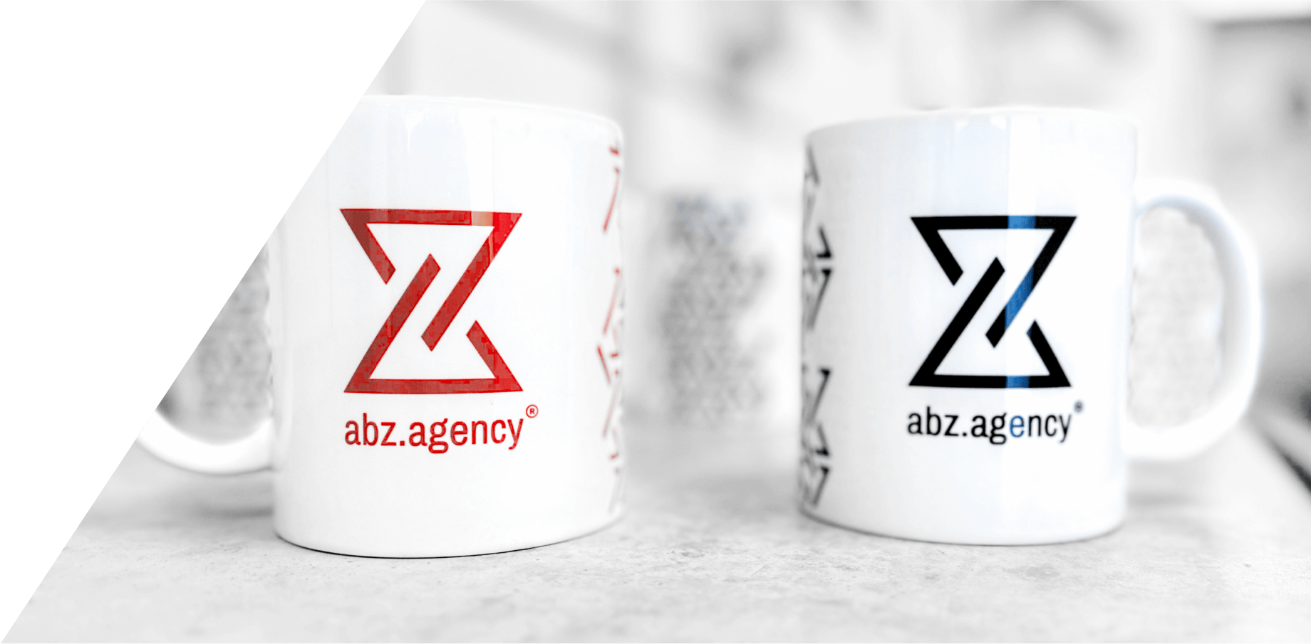 Mugs of abz.agency® in black and red variants